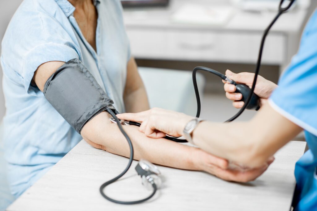 Nurse measuring blood pressure of a senior patient